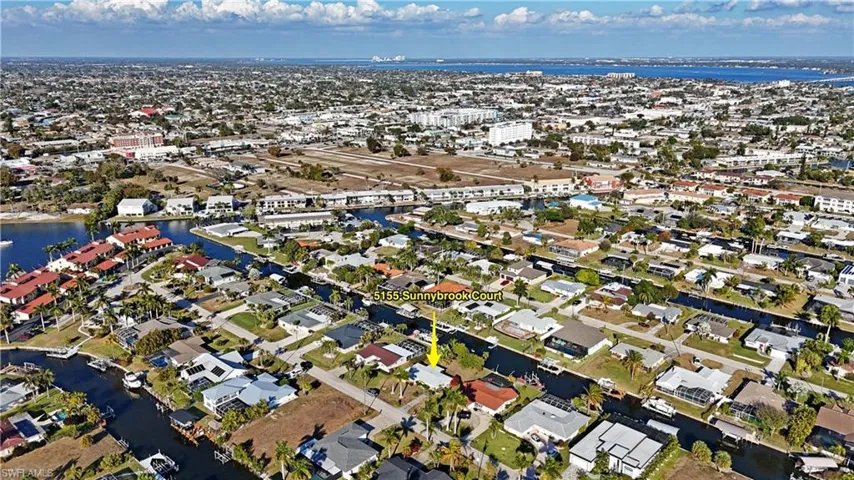 Aerial perspective of suburban area featuring a large body of water