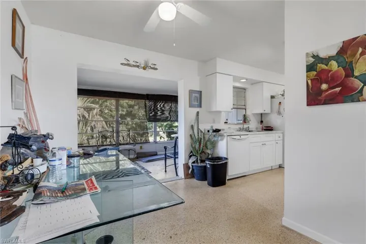 Dining space featuring dark speckled floor and a ceiling fan