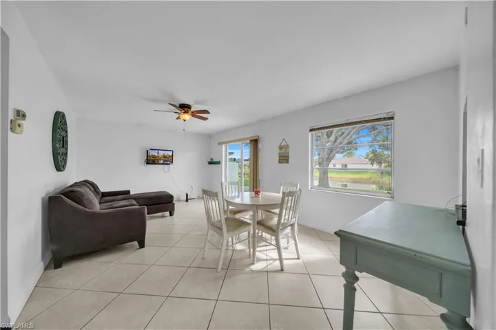 Dining area featuring ceiling fan and light tile patterned floors