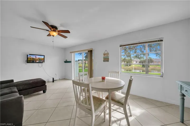 Dining space featuring a ceiling fan and light tile patterned floors