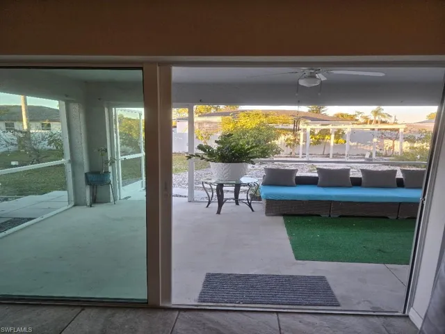 Doorway to outside featuring ceiling fan