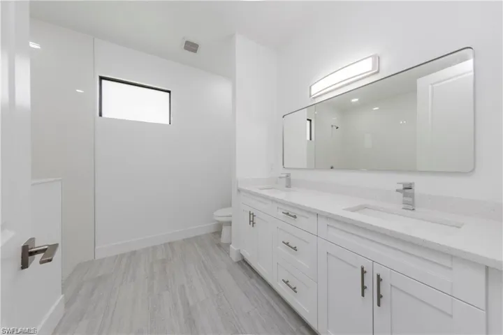 Bathroom with double vanity and a shower