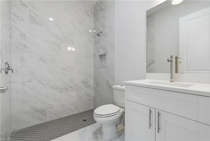 Full bath featuring vanity and a stall shower