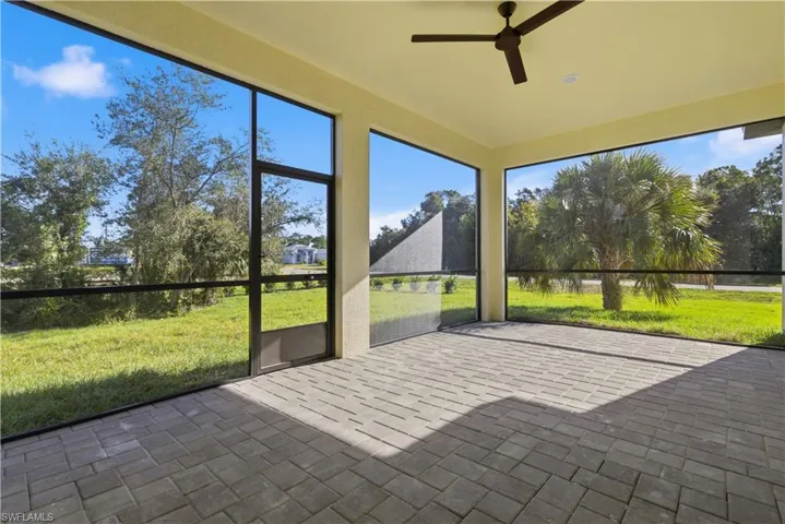 Unfurnished sunroom featuring a ceiling fan
