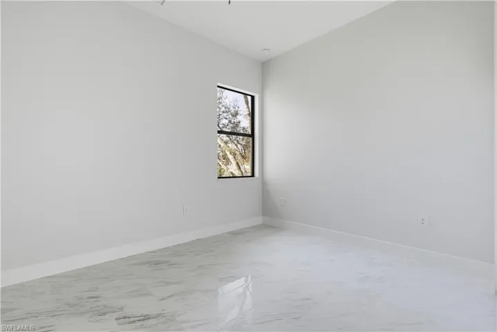 Empty room with light marble finish flooring and baseboards