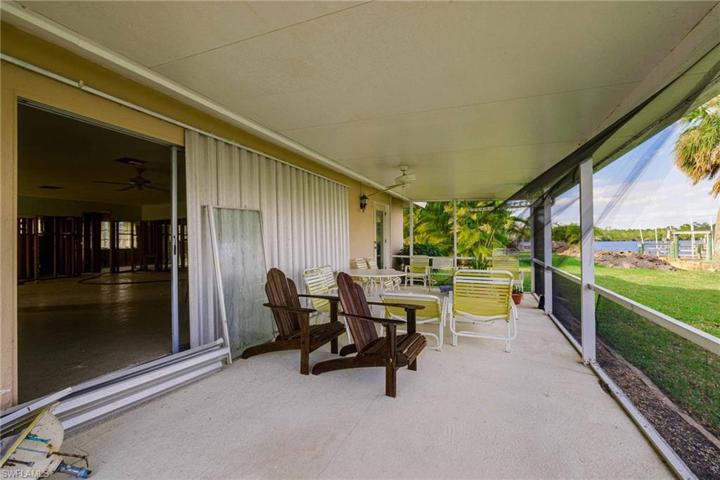 A massive screened porch has some missing/damaged screens