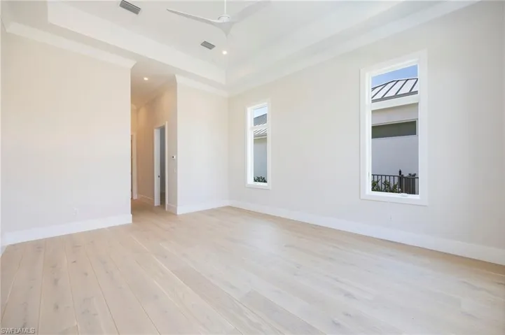 The primary bedroom features dual walk-in closets leading to the primary bathroom.