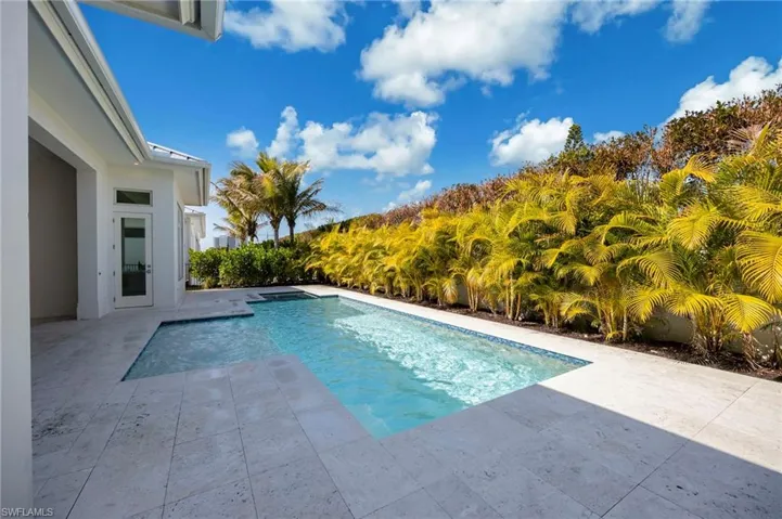 The heated salt pool features flush spa, sunshine, and privacy! Landscaping is new and will mature.