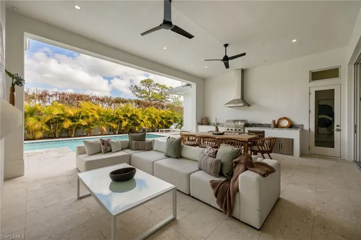 Covered outdoor living. 4542 Seagrove is listed as unfurnished. This home has been staged with furniture and accessories, all of which is available for purchase. Unfurnished  photos are included in the listing photo album.