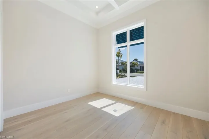 Bedroom 4 is situated in the front of the home with a large window, making it a perfect flex room as an office, den, or guest space.