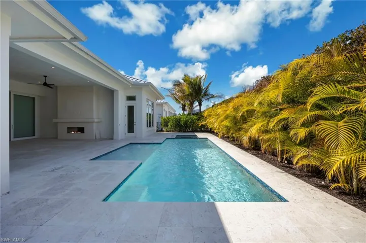 The heated salt pool features flush spa, sunshine, and privacy! Landscaping is new and will mature.