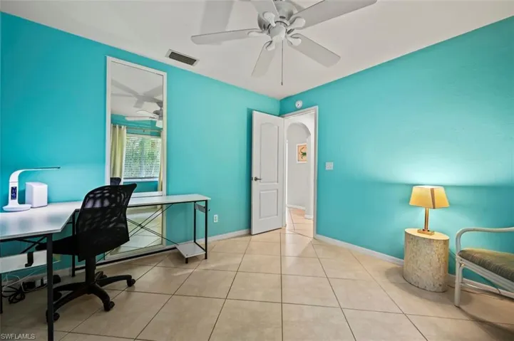 Office space featuring ceiling fan and tile patterned floors