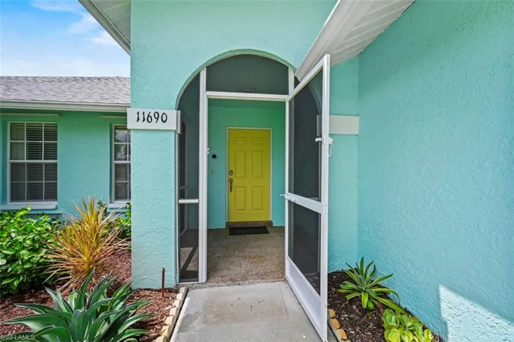 Doorway to property featuring stucco siding