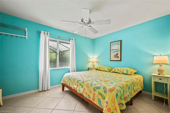 Bedroom with tile patterned floors and ceiling fan