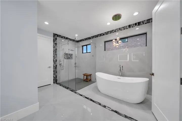 Freestanding soaking tub with floor-mounted faucet