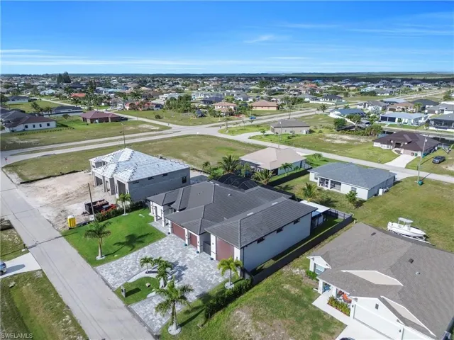 Aerial overview of a residential neighborhood featuring established homes and new construction