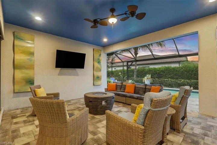 View of patio / terrace with an outdoor living space, an outdoor pool, glass enclosure, ceiling fan, and a sunroom