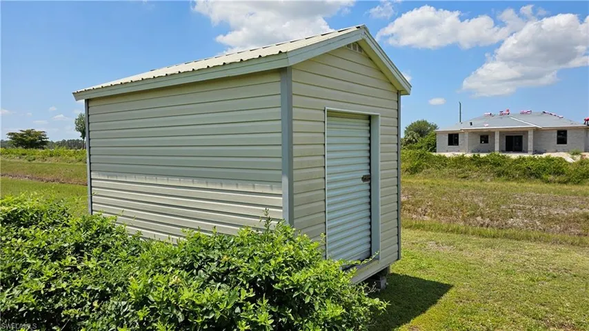 View of outbuilding with a yard