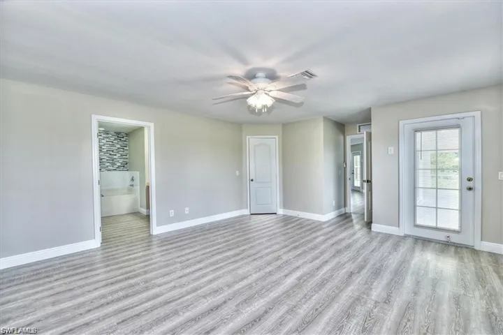 Unfurnished room with ceiling fan and light hardwood / wood-style floors