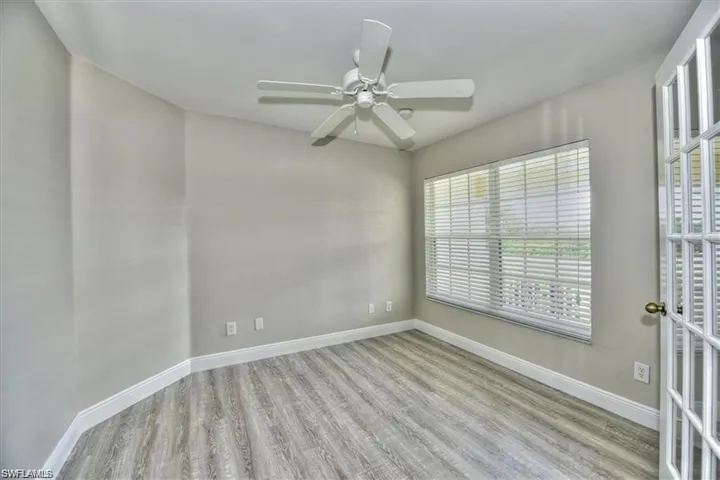 Unfurnished room with ceiling fan and light hardwood / wood-style floors