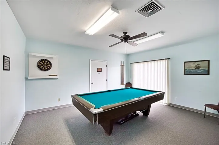 Rec room with pool table, carpet flooring, a ceiling fan, and a textured ceiling