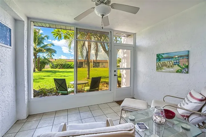 Sunroom featuring a ceiling fan