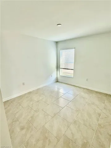 Spare room with light tile patterned flooring