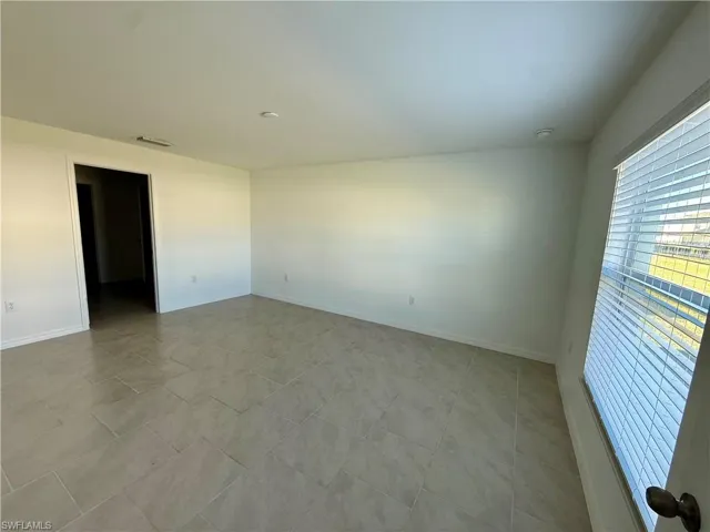 Unfurnished room with baseboards
