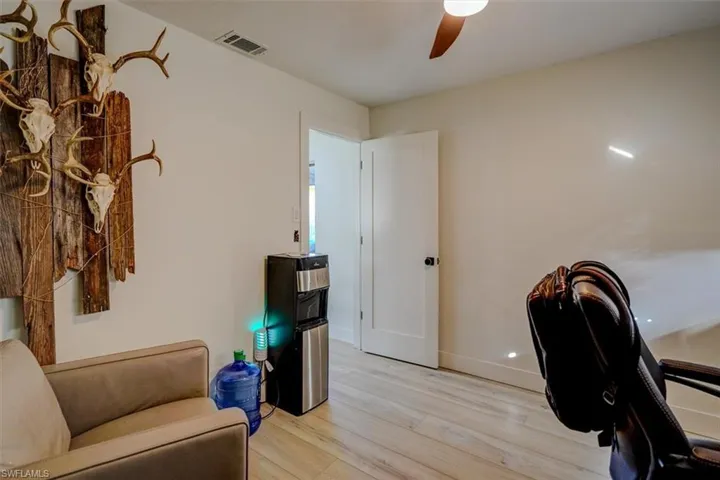 Office space featuring ceiling fan and light hardwood / wood-style flooring