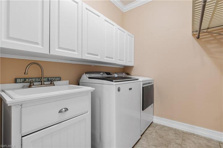 Laundry room with added upper cabinets and sink