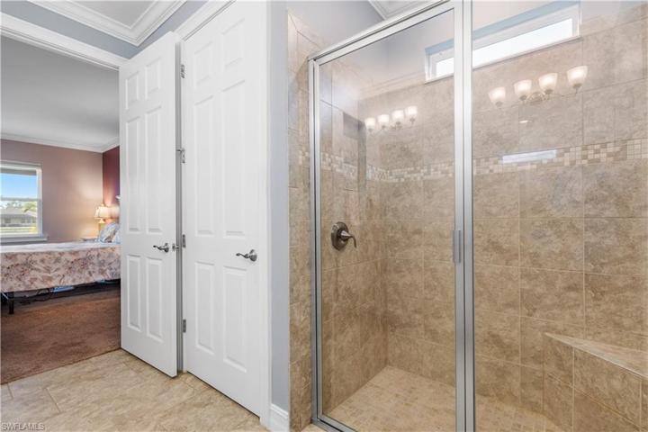 Spacious master bathroom with tile showe and glass shower door