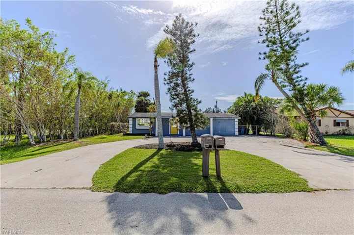 Ranch-style home with a garage and a front lawn