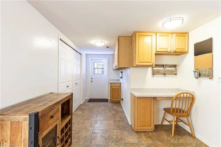 Kitchen with light brown cabinets and a kitchen breakfast bar
