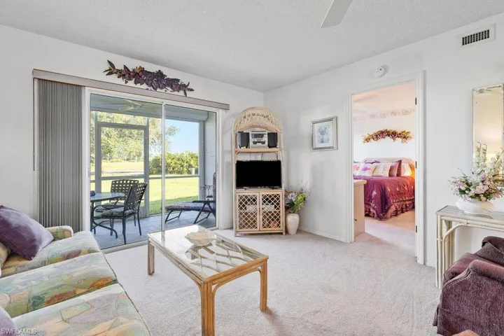 Carpeted living room featuring a textured ceiling