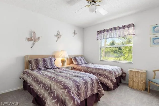 Bedroom with ceiling fan and carpet floors