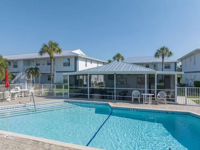 View of swimming pool with a sunroom and a patio
