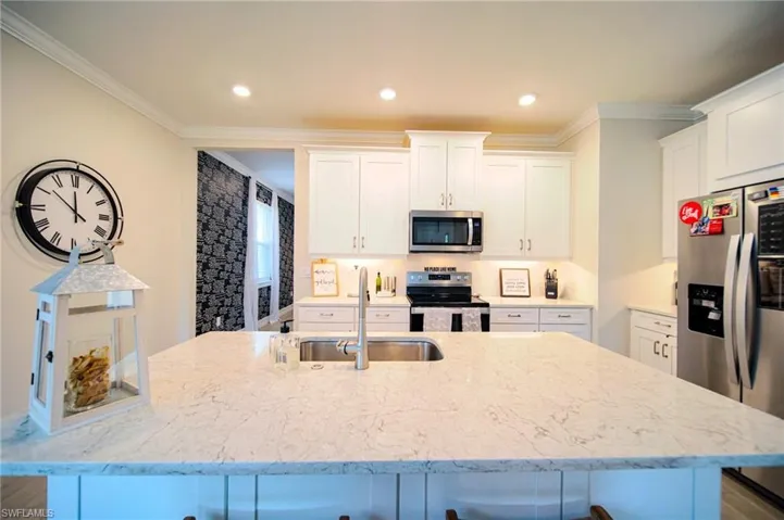 The Island Kitchen Comes With Granite Countertops, Tile Backsplash, Stainless Steel Appliances, 42 Inch White Shaker Uppers, Under Cabinet Lighting, And An Oversized Walk-In Pantry
