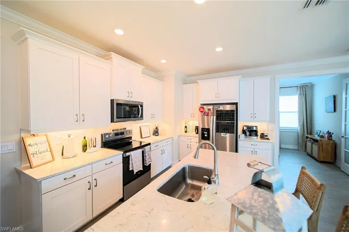 The Island Kitchen Comes With Granite Countertops, Tile Backsplash, Stainless Steel Appliances, 42 Inch White Shaker Uppers, Under Cabinet Lighting, And An Oversized Walk-In Pantry