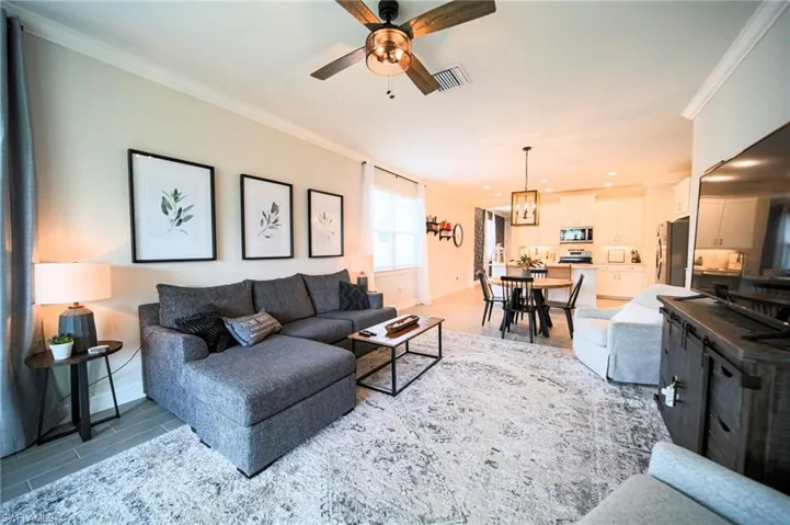 The Living Room Has A Great View Of The Screened-In Lanai And Has Custom Lighting And Is Fully Furnished With All That You Need To Have That Florida Experience!