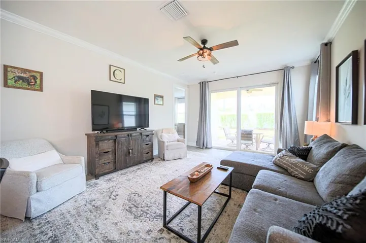 The Living Room Has A Great View Of The Screened-In Lanai And Has Custom Lighting And Is Fully Furnished With All That You Need To Have That Florida Experience!