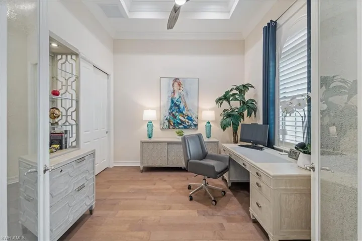 Office featuring ornamental molding, light wood-type flooring, ceiling fan, and baseboards