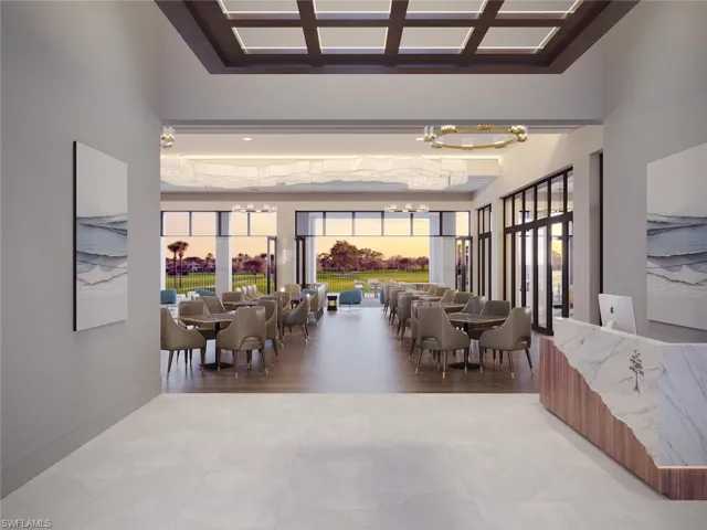Dining space with a high ceiling, baseboards, and a notable chandelier