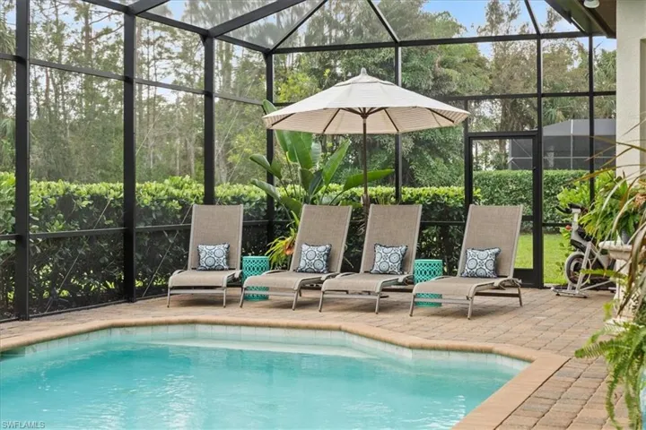 Outdoor pool with a lanai and a patio area