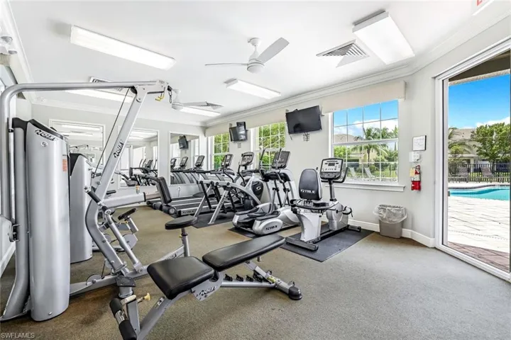 Exercise room featuring ceiling fan and crown molding