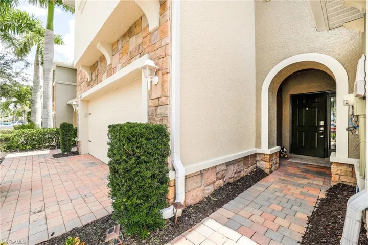 View of exterior entry featuring a garage