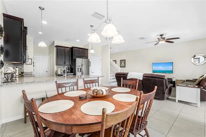Dining room with light tile patterned flooring, sink, and ceiling fan