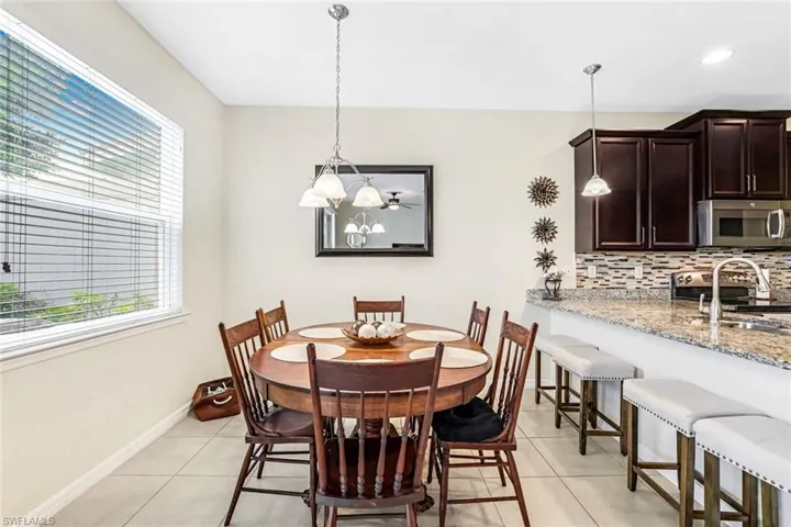 Dining room featuring sink, a chandelier, and light tile patterned floors