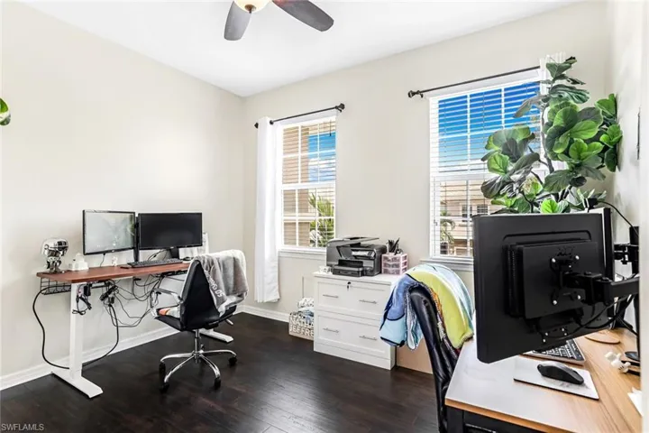 Office with ceiling fan and dark hardwood / wood-style flooring