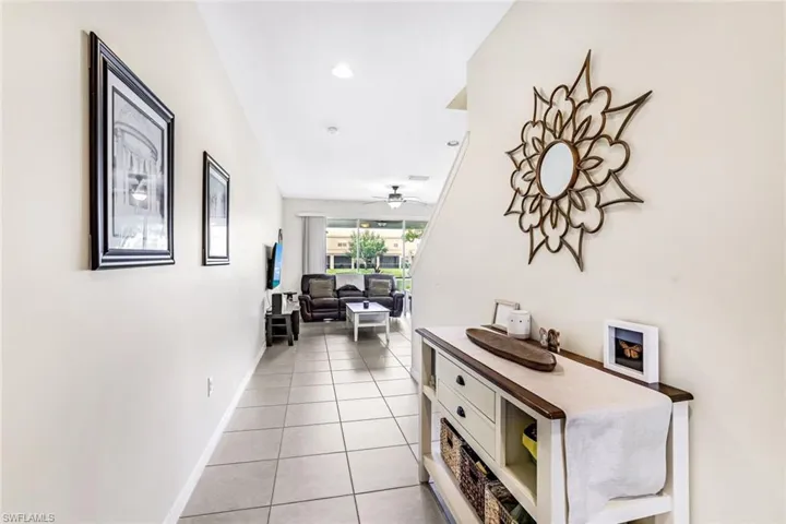 Corridor featuring light tile patterned floors