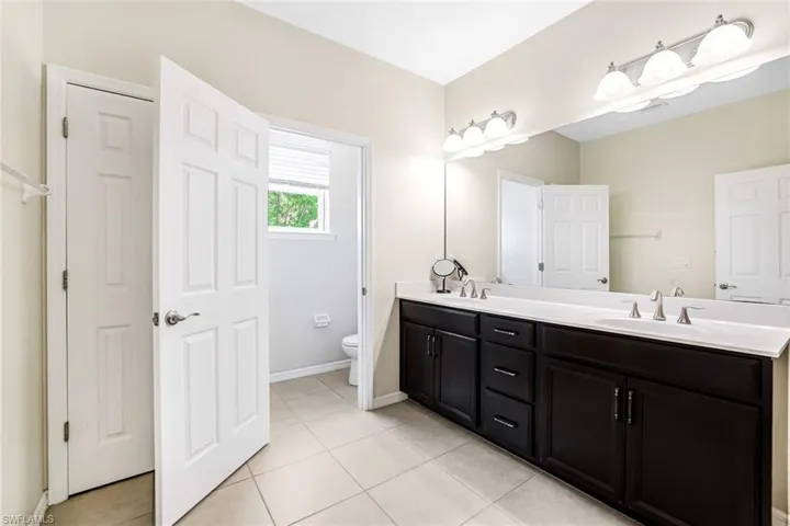 Bathroom with tile patterned floors, toilet, and vanity